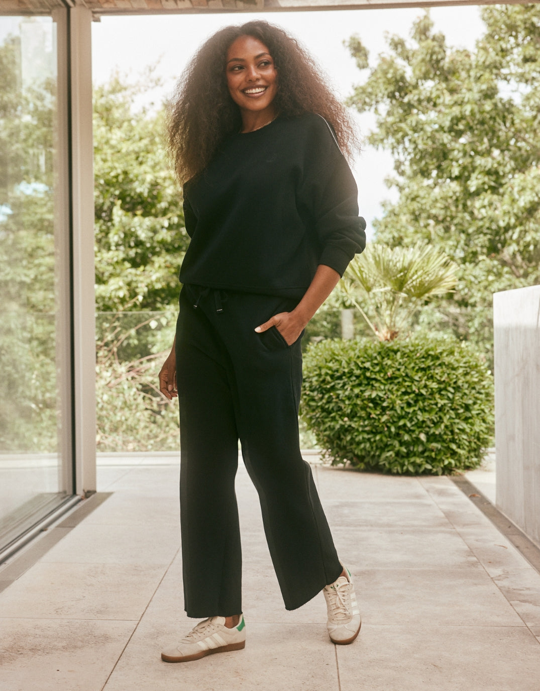 Image of a model wearing Pants. Productname: Fleece Lounger Pant - in Black colour by brand - White & Co.