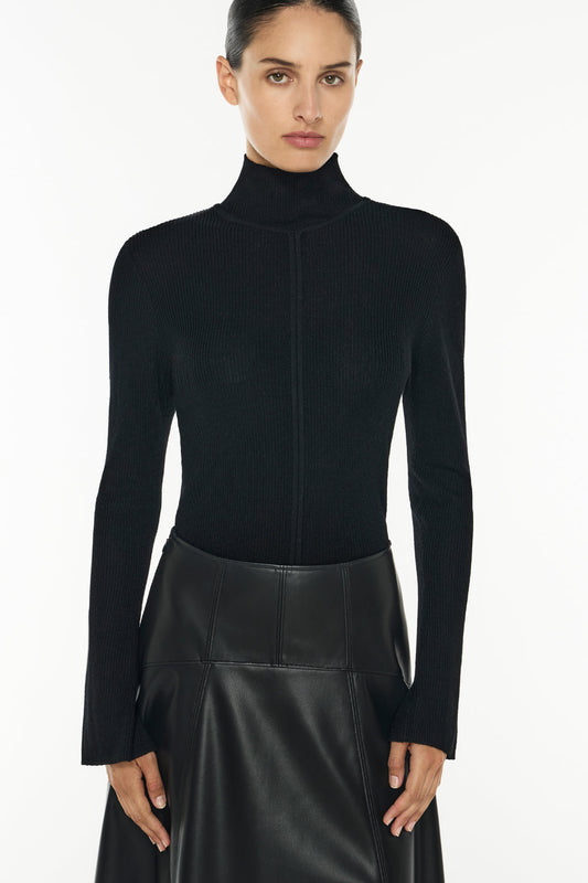 Image of a model wearing Tops. Productname: Lines Of Distinction Knit Top in Black colour by brand - Manning Cartell