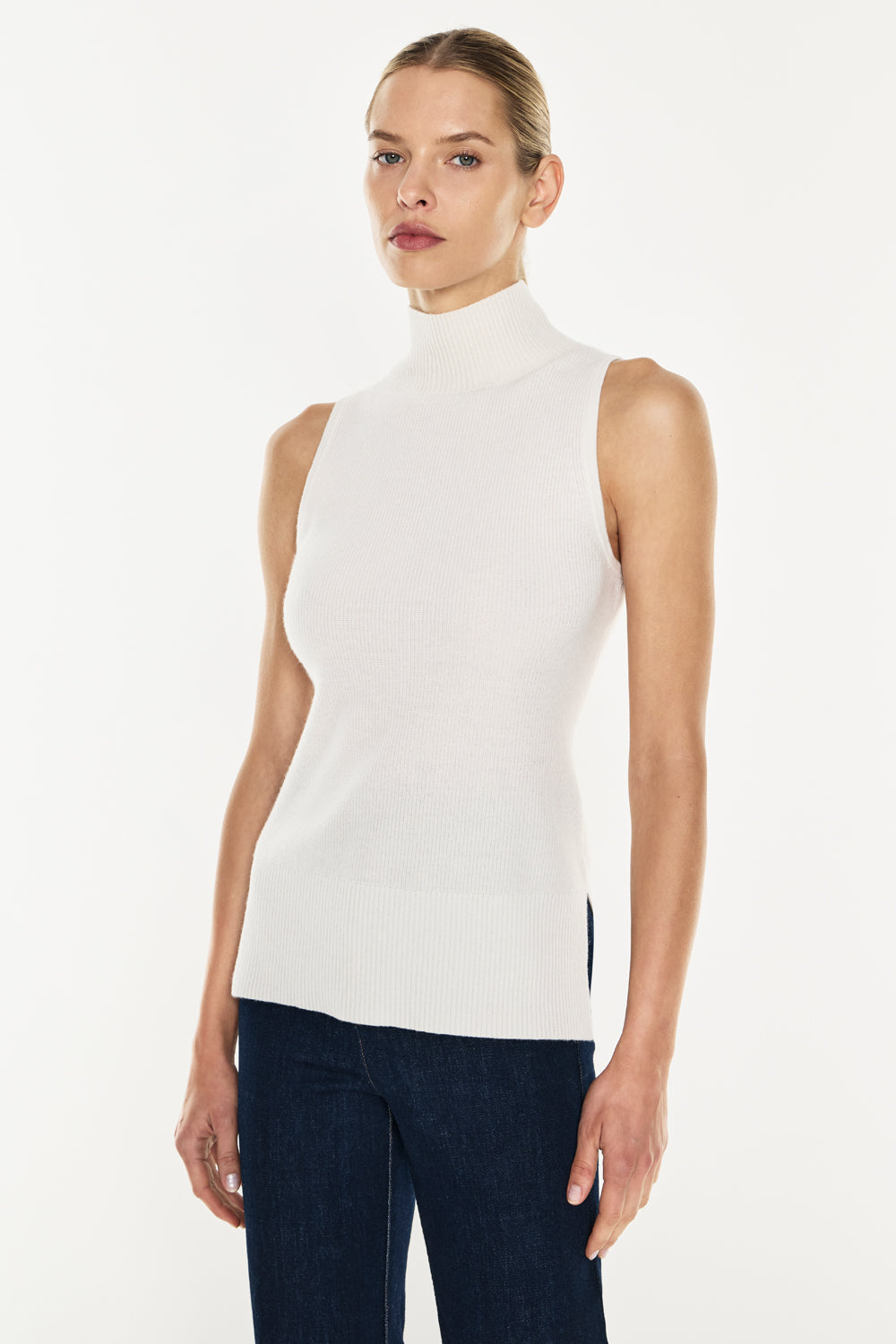 Image of a model wearing Tops. Productname: Funnel Vision Knit Top in Ivory colour by brand - Manning Cartell