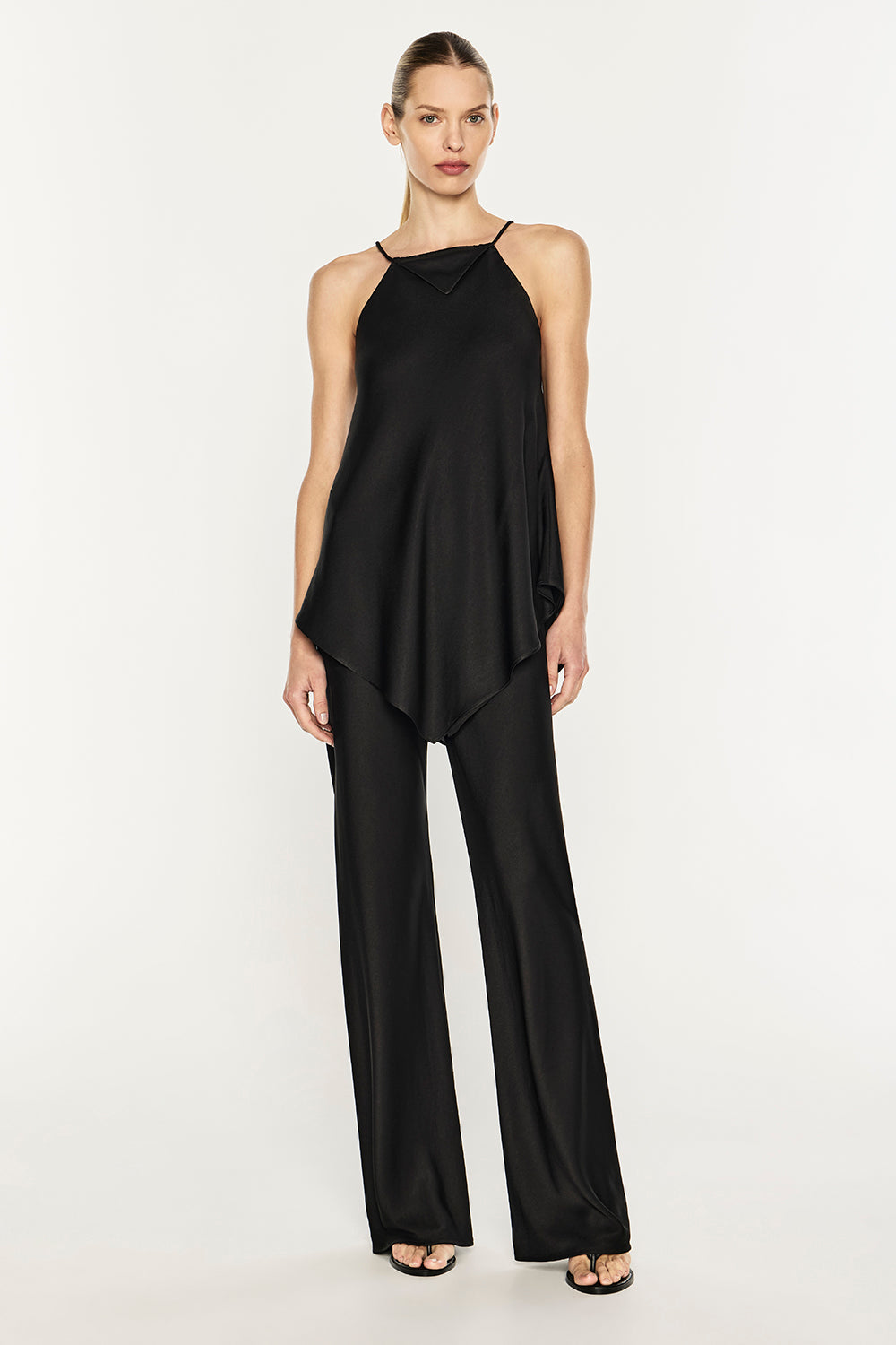 Image of a model wearing Tops. Product name - Low Down Rhythm Racer Top in Black colour by brand - MANNING CARTELL