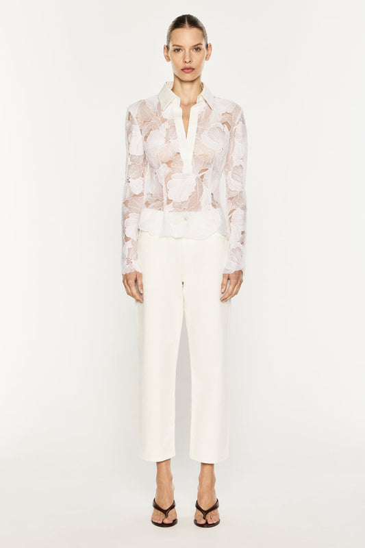 Image of a model wearing Tops. Product name - Sheer Force Polo Top in White colour by brand - MANNING CARTELL