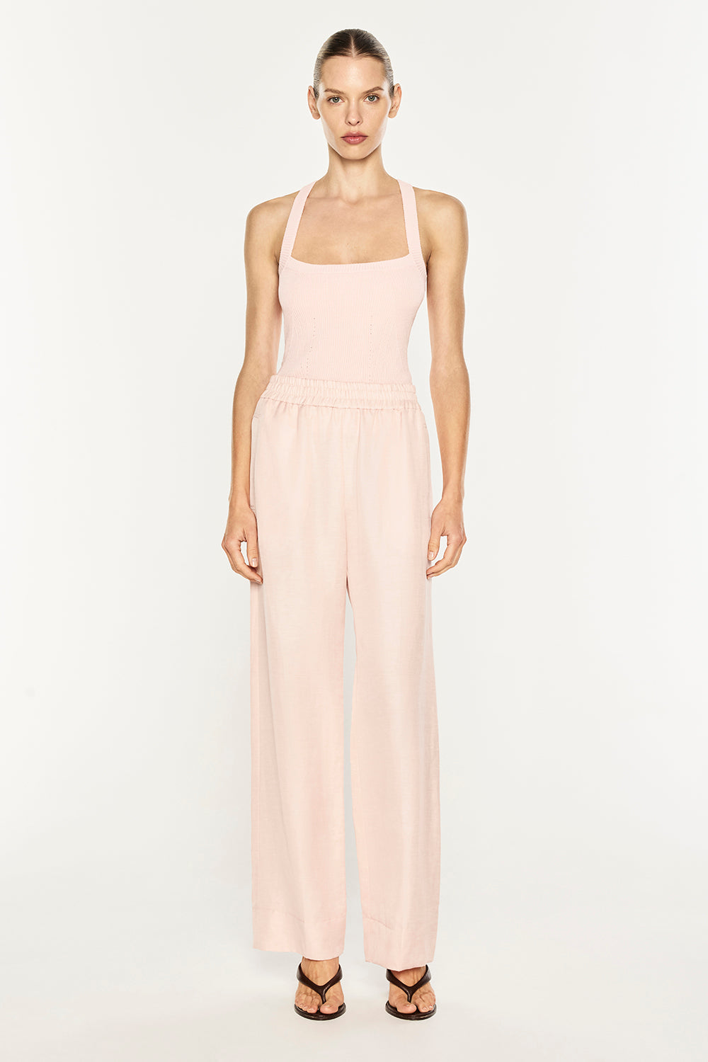 Image of a model wearing Pants. Product name - Rich Mix Pull On Pant in Blush Pink colour by brand - MANNING CARTELL
