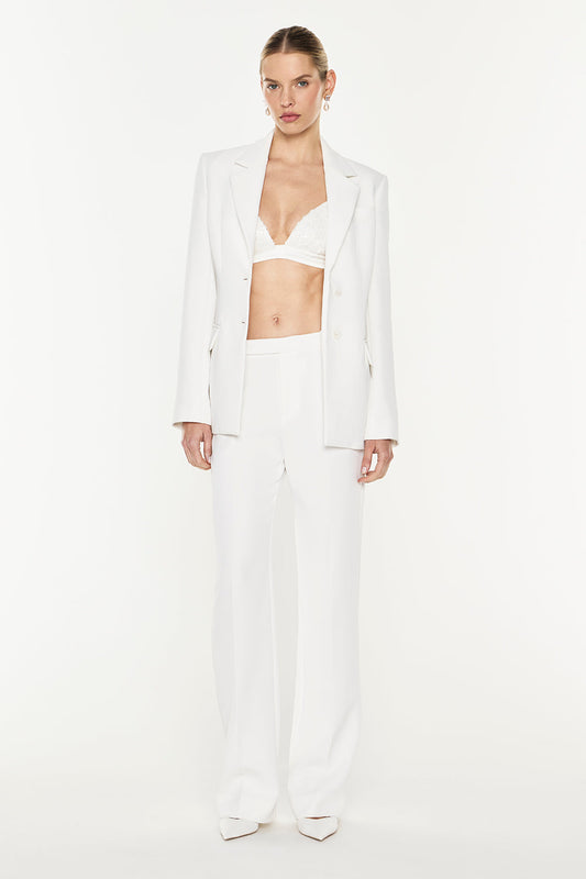 Image of a model wearing Pants. Product name - Modern Master Pant in Chalk colour by brand - MANNING CARTELL