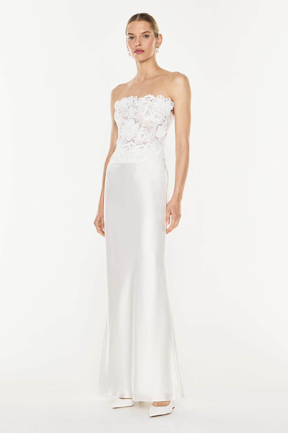 Image of a model wearing Skirts. Product name - Luminous Bias Maxi Skirt in White colour by brand - MANNING CARTELL