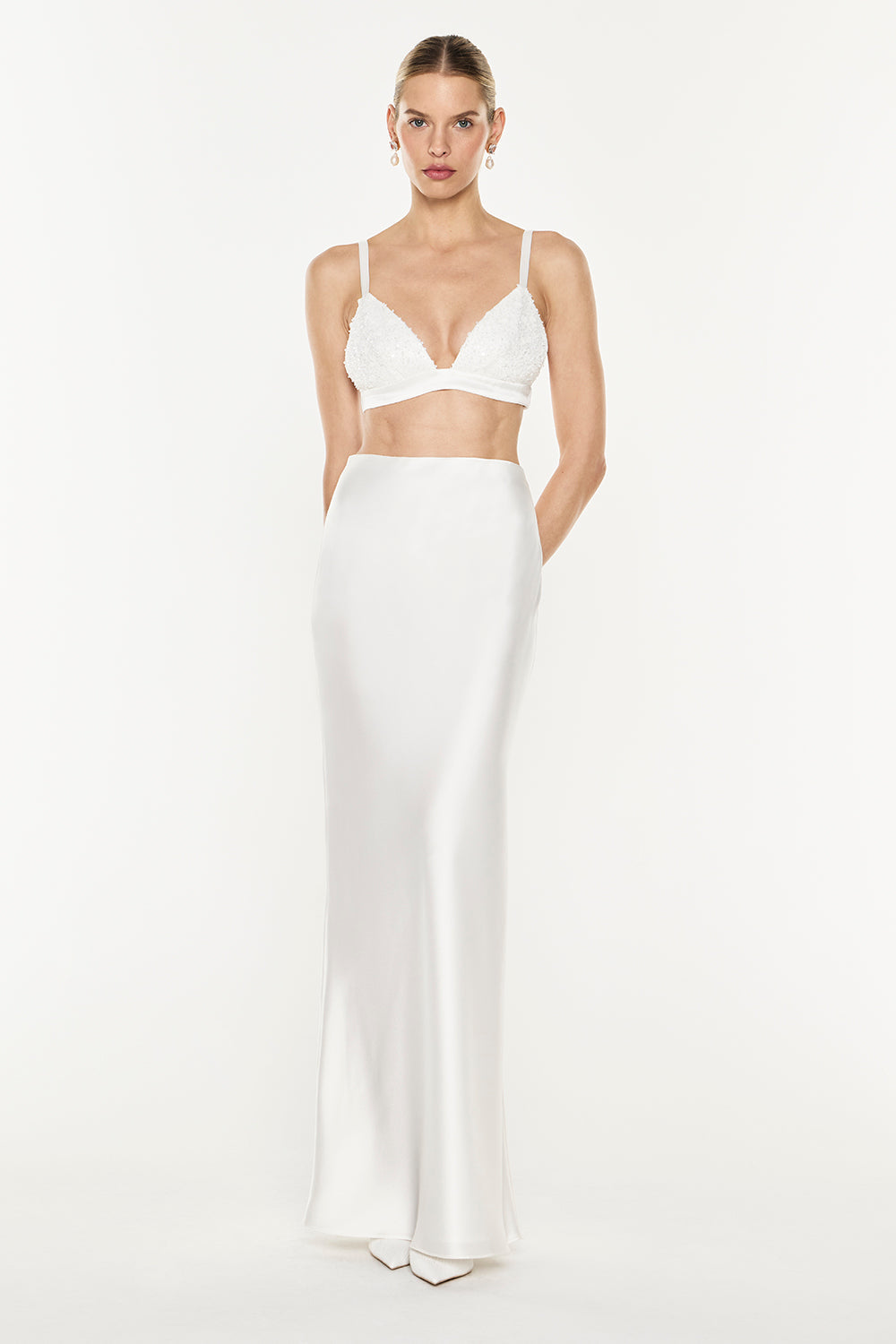 Image of a model wearing Tops. Product name - Amplified Heart Bralette in White colour by brand - MANNING CARTELL