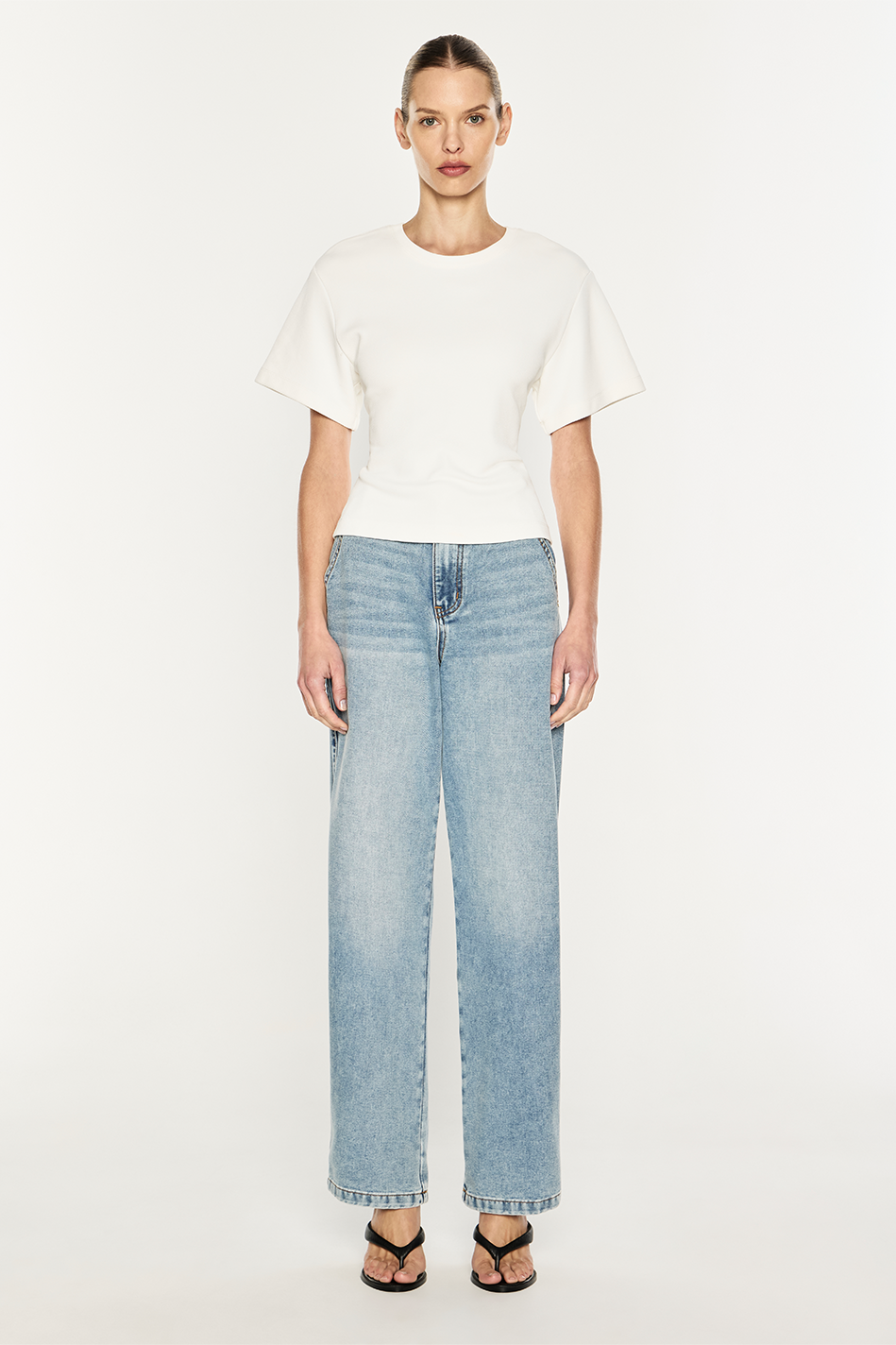 Image of a model wearing Tops. Product name - Triple Corset Tee in Ivory colour by brand - MANNING CARTELL