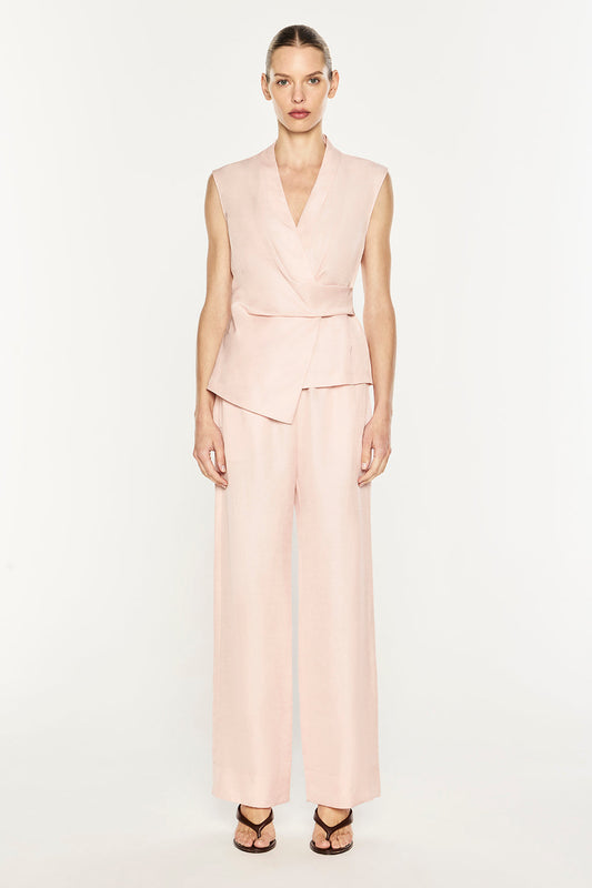 Image of a model wearing Tops. Product name - Rich Mix Wrap Top in Blush Pink colour by brand - MANNING CARTELL