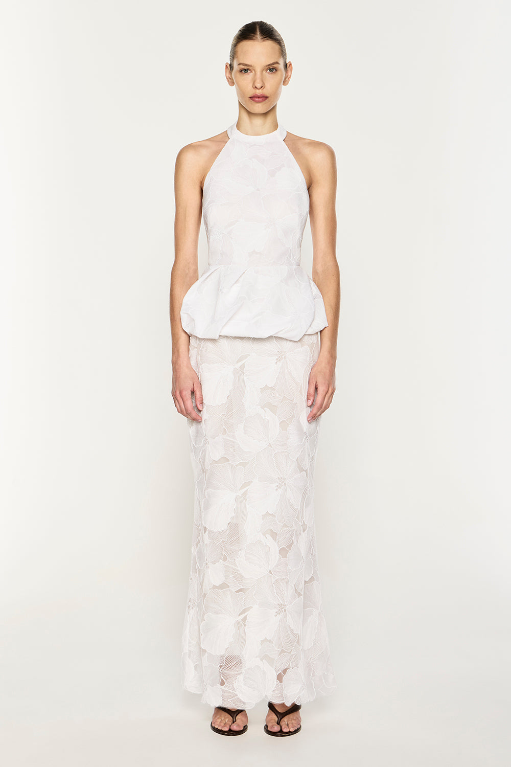 Image of a model wearing Tops. Product name - Sheer Force Peplum Top in White colour by brand - MANNING CARTELL