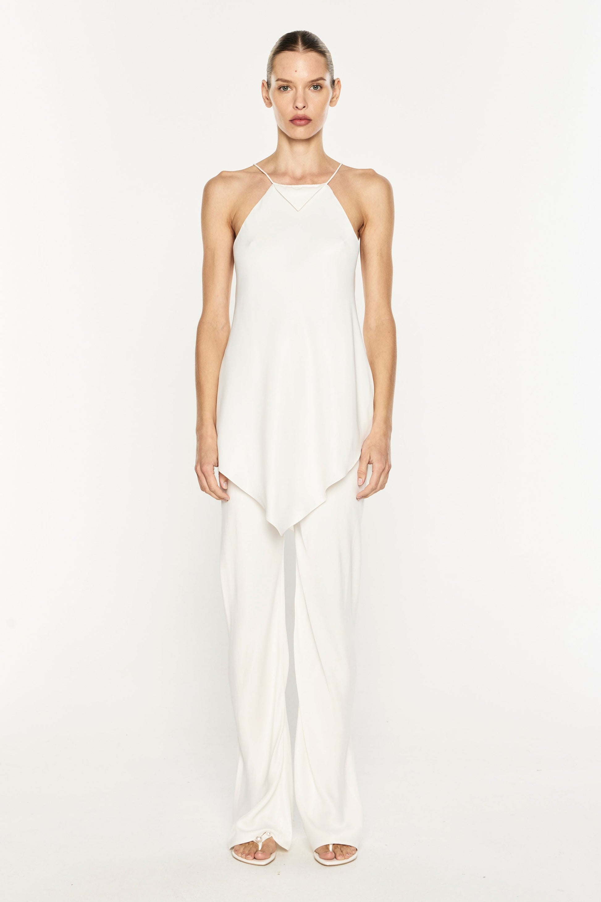 Image of a model wearing Pants. Product name - Oblique Bias Pant in White colour by brand - MANNING CARTELL