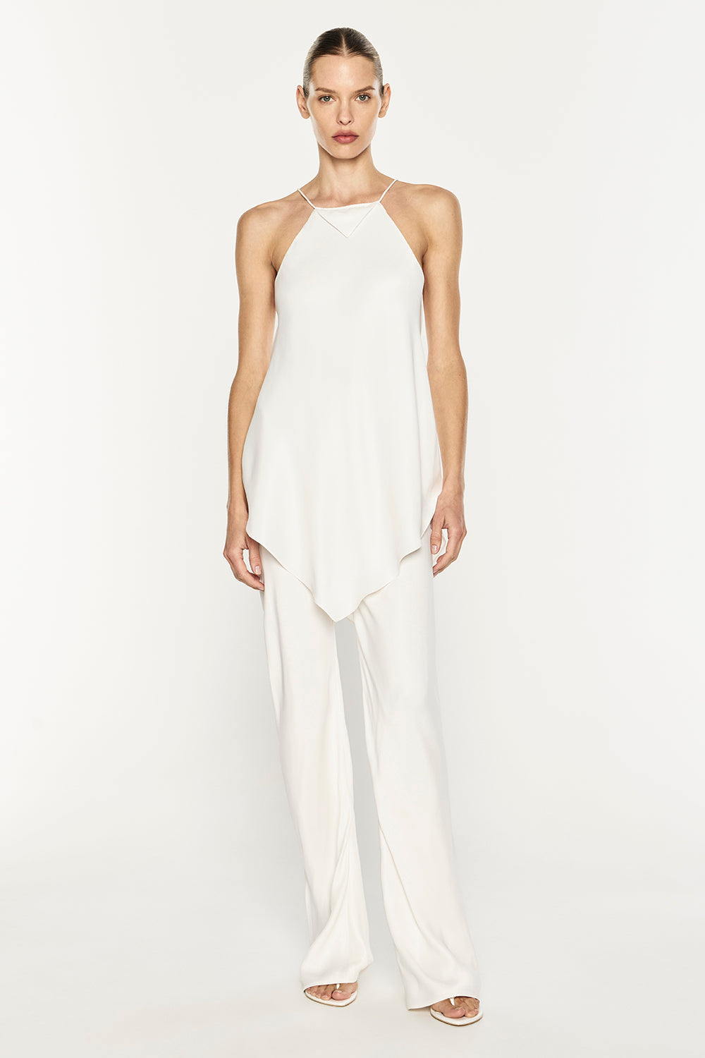 Image of a model wearing Pants. Product name - Oblique Bias Pant in White colour by brand - MANNING CARTELL