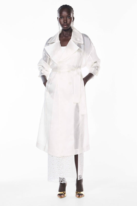 Image of a model wearing Outerwear. Productname: Organza Trench in IVORY colour by brand - Manning Cartell