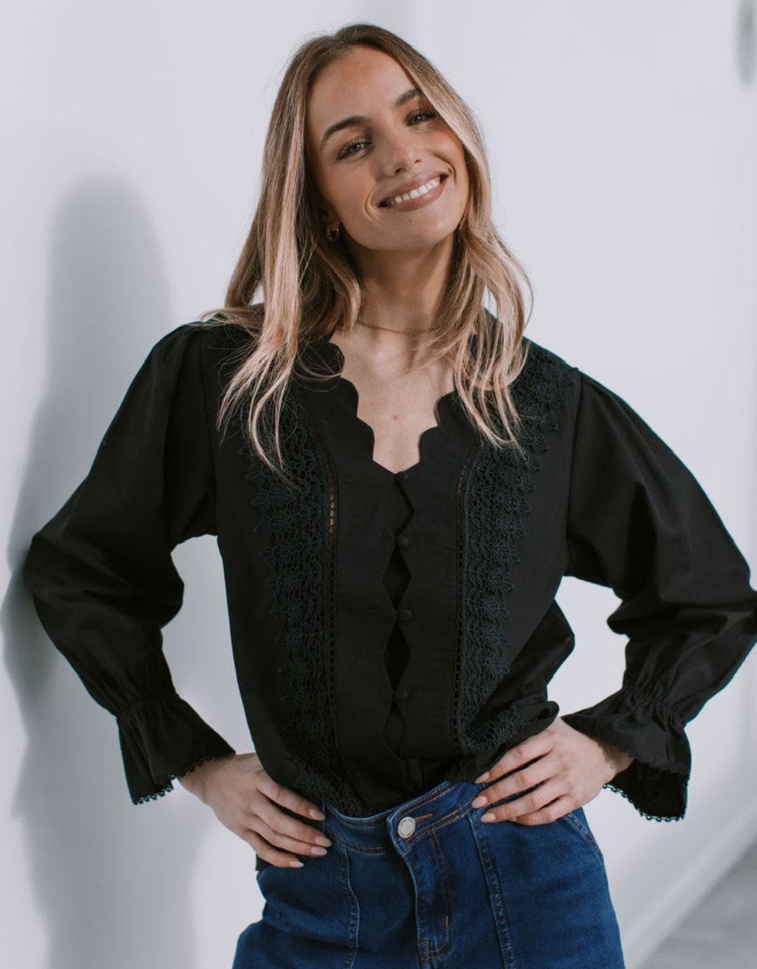 Image of a model wearing Tops. Productname: Boscolo Ruffle Cuff Shirt - in Black colour by brand - 132 Fashion