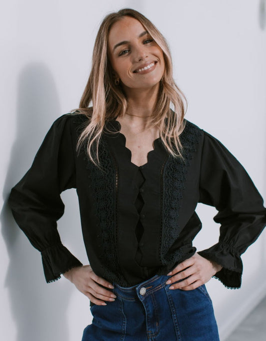 Image of a model wearing Tops. Productname: Boscolo Ruffle Cuff Shirt - in Black colour by brand - 132 Fashion