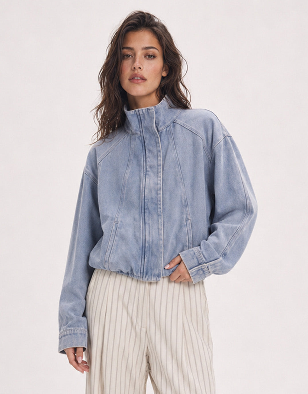 Image of a model wearing Outerwear. Product name - Leni Denim Bomber Jacket Light Wash Denim in Light Wash Denim colour by brand - 132 Fashion