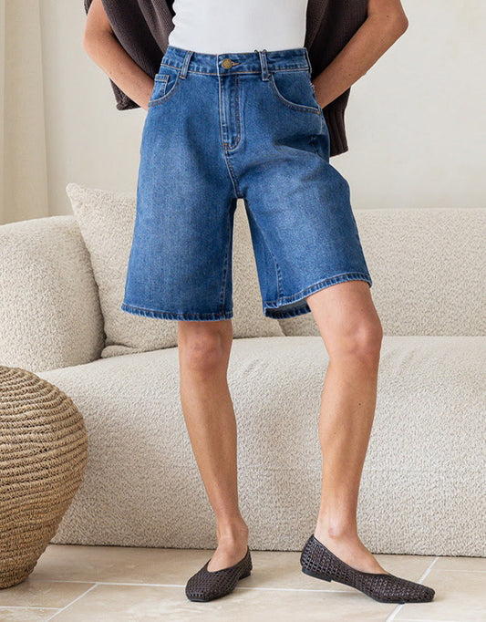 Image of a model wearing Shorts. Product name - Lucie Denim Short Mid Wash in Mid Wash colour by brand - 132 Fashion