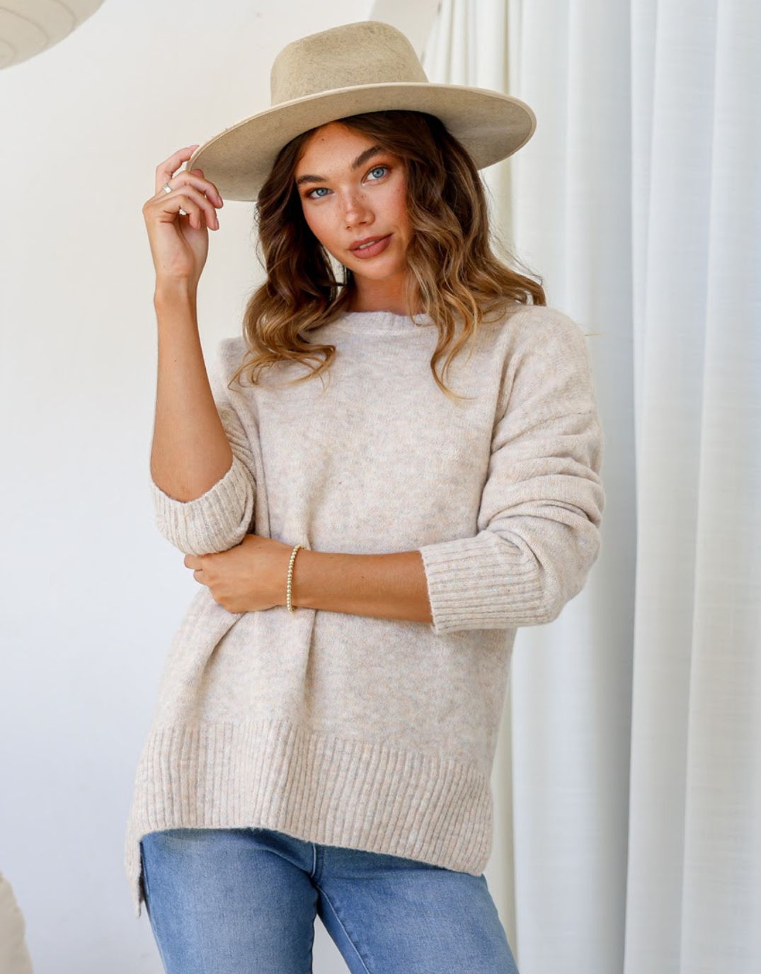 Image of a model wearing Outerwear. Productname: Maisie Hi-Low Knit - in Latte colour by brand - 132 Fashion
