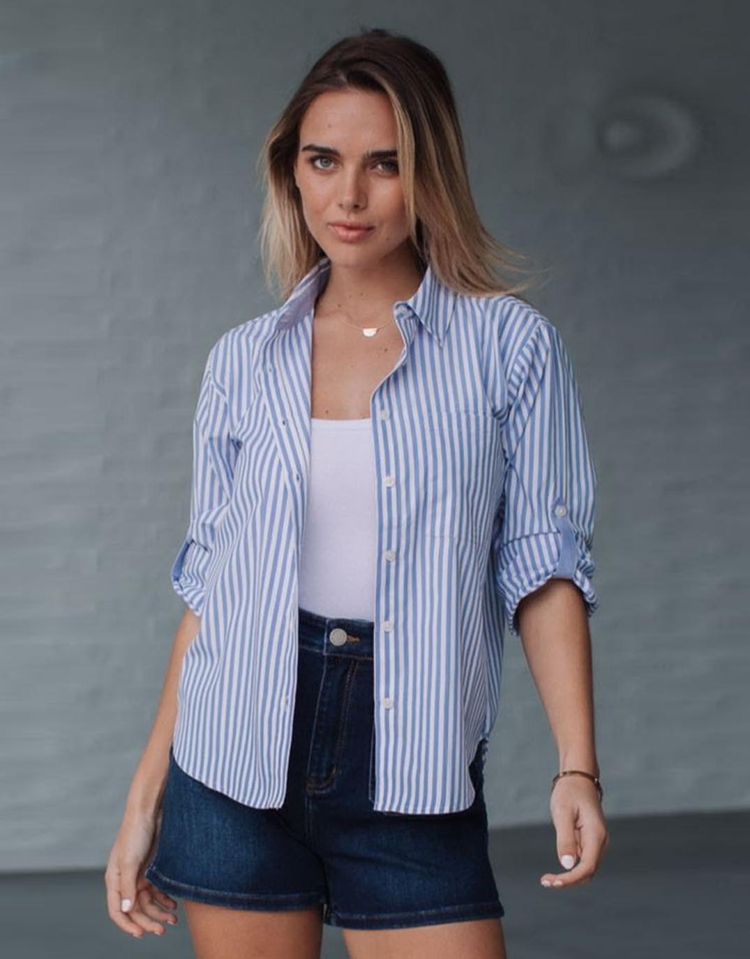 Image of a model wearing Tops. Productname: Romi Roll Tab Shirt - in Blue/White colour by brand - 132 Fashion