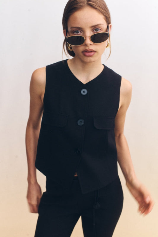 Image of a model wearing Tops. Product name - Anouk Vest Black in Black colour by brand - Blanca Studio