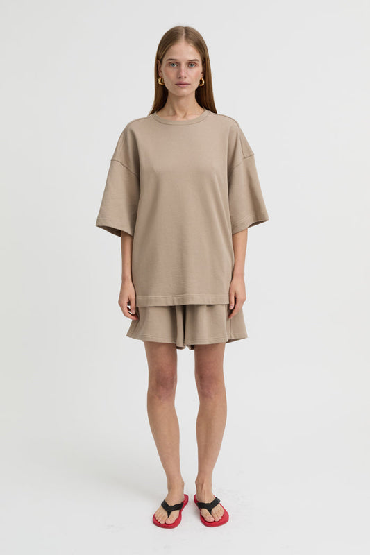 Image of a model wearing Shorts. Product name - Hendrix Shorts Taupe in Taupe colour by brand - Blanca Studio