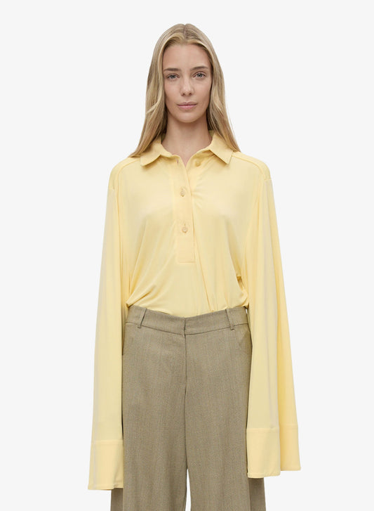 Image of a model wearing Tops. Productname: CHRISTOPHER ESBER Deconstruct Denim Long Sleeve Polo in Butter colour by brand - CHRISTOPHER ESBER