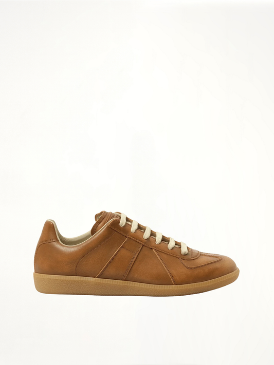 Image of Sneakers. Product name - Vegetable Dyed Replica Sneaker in Brown colour by brand - MAISON MARGIELA
