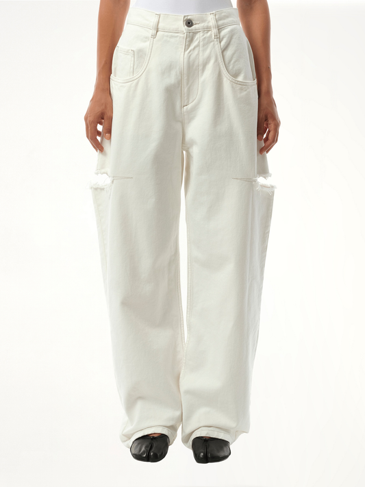 Image of a model wearing Denim. Productname: MAISON MARGIELA Slash Loose Fit Denim Jeans in WHITE colour by brand - MAISON MARGIELA