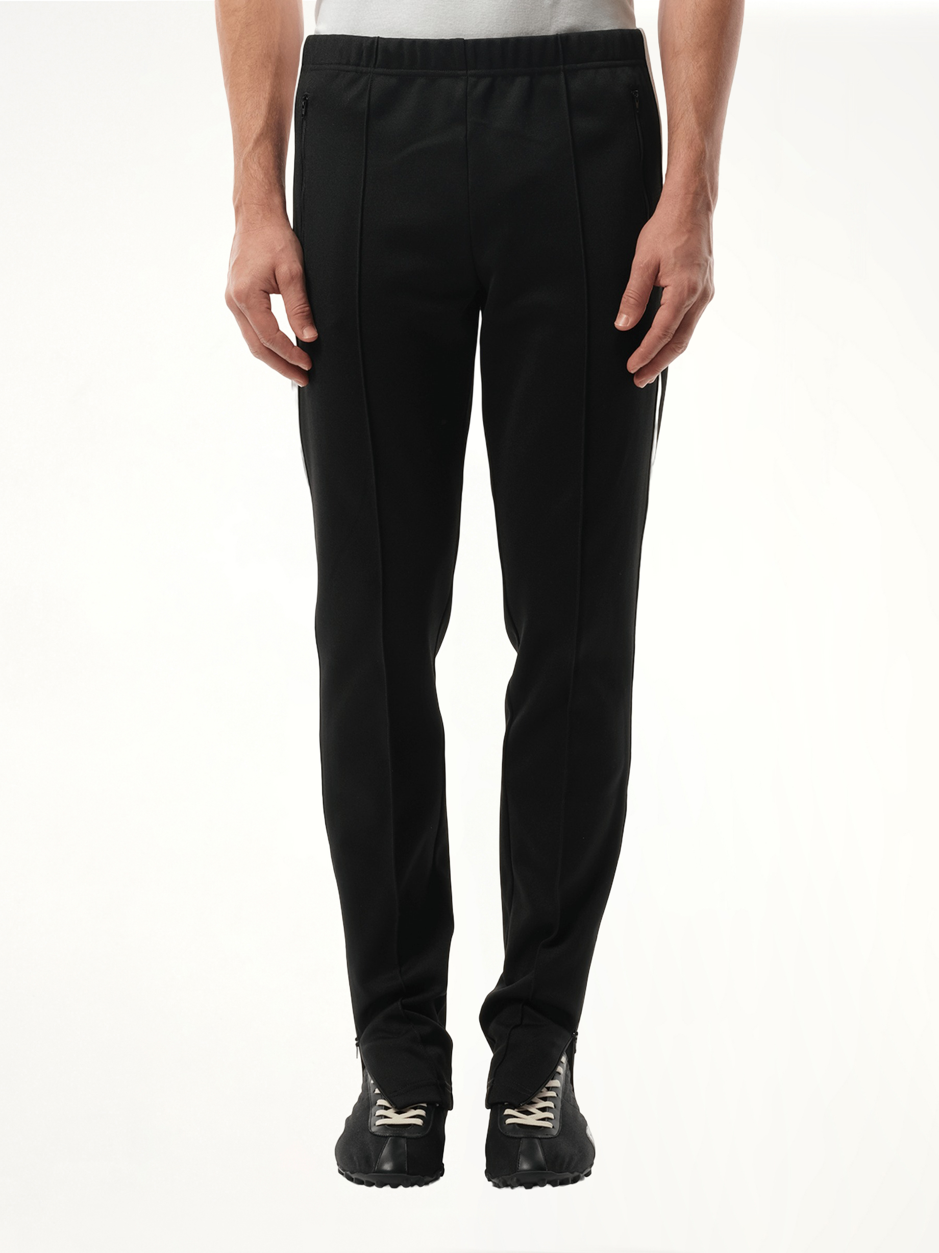 Image of a model wearing Pants. Productname: MAISON MARGIELA Track Pants in BLACK colour by brand - MAISON MARGIELA