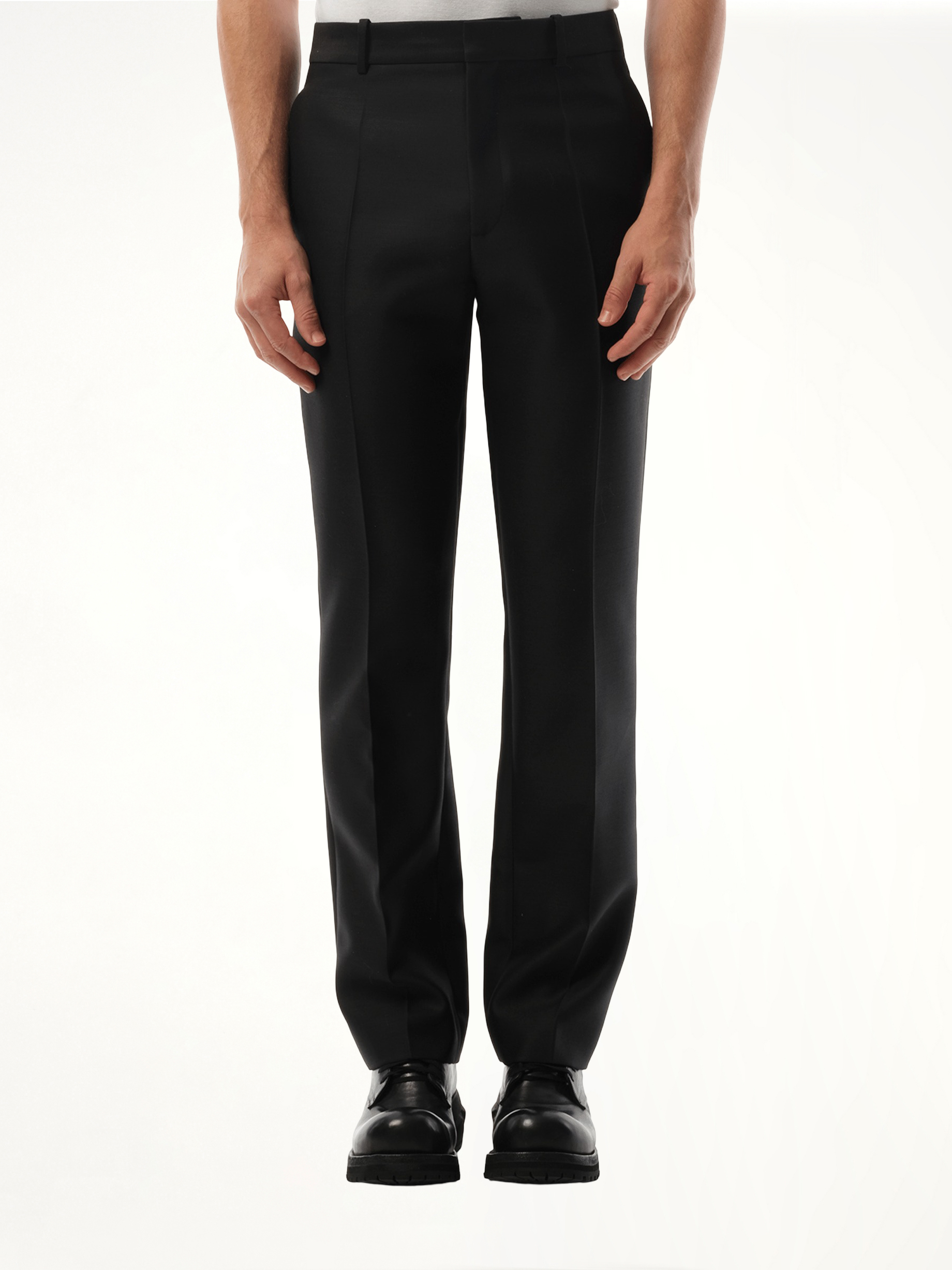 Image of a model wearing Pants. Product name - Slim Fit Trouser in Black colour by brand - LOEWE