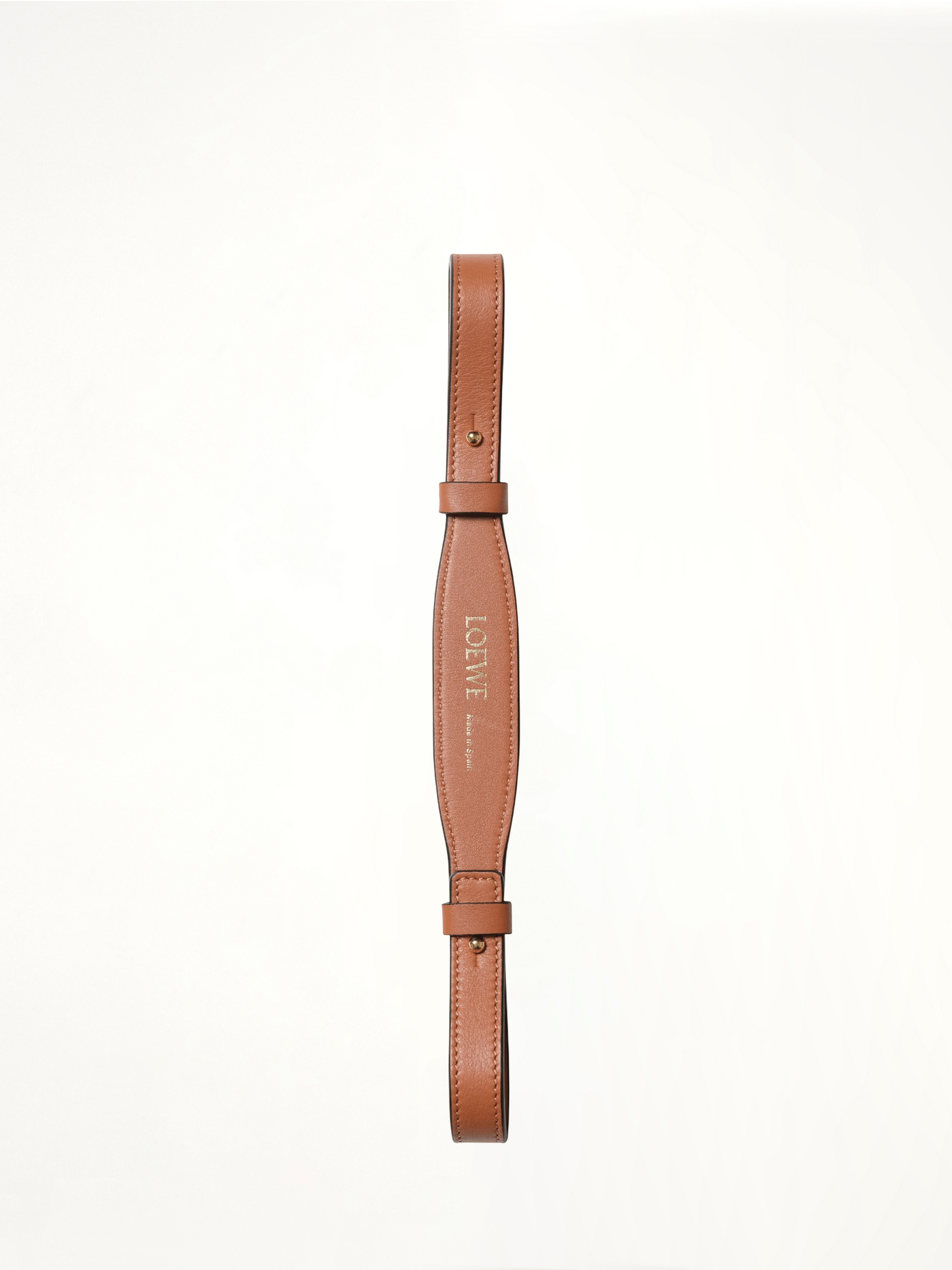 Image of a model wearing Shorts. Product name - Branded Short Strap in Tan colour by brand - LOEWE