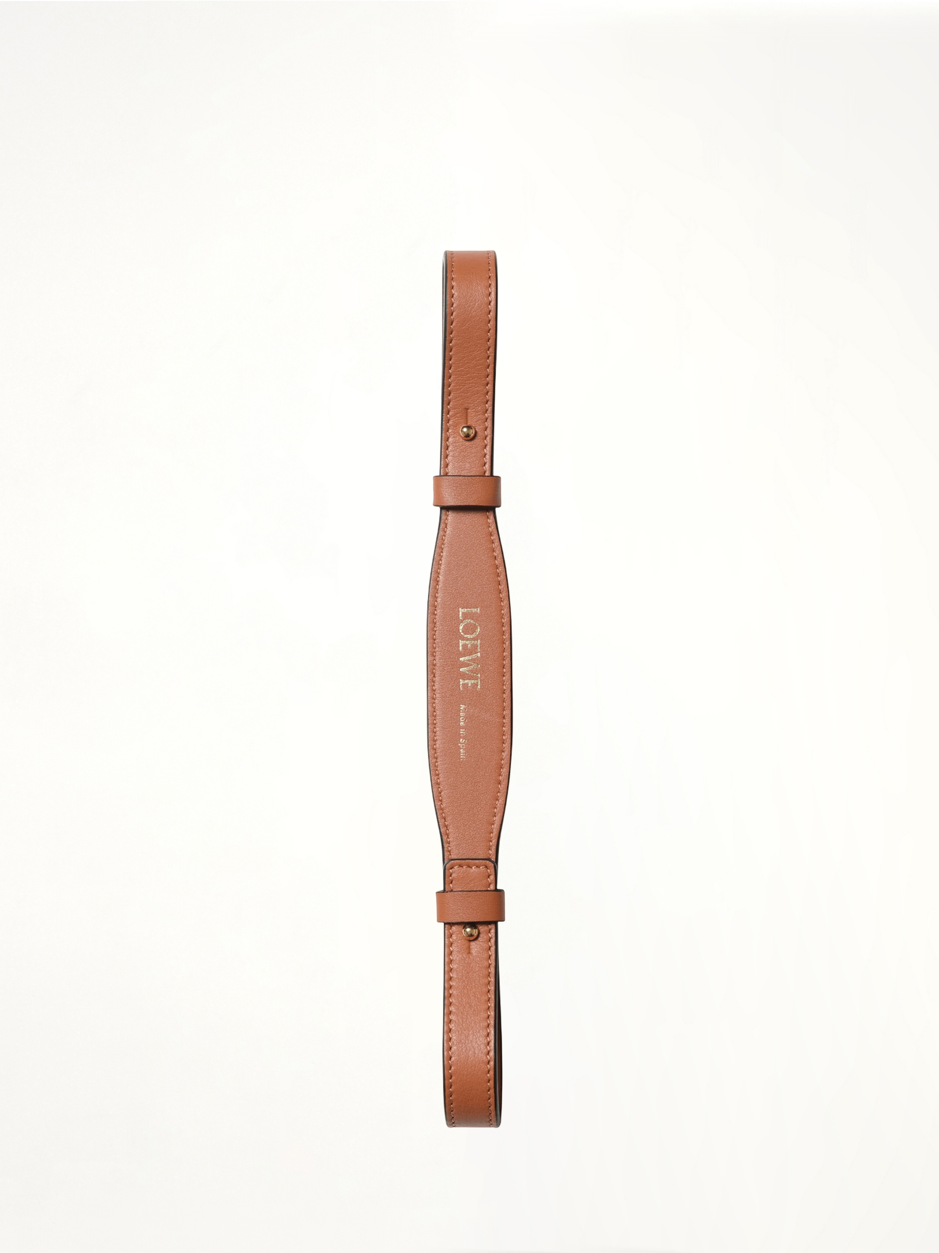 Image of a model wearing Shorts. Product name - Branded Short Strap in Tan colour by brand - LOEWE