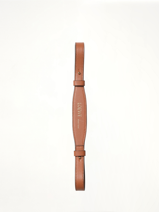 Image of a model wearing Shorts. Product name - Branded Short Strap in Tan colour by brand - LOEWE