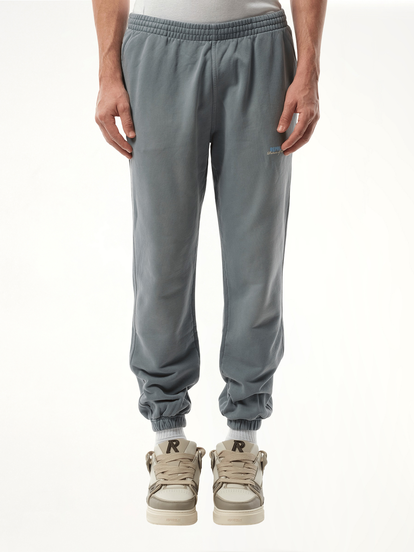 Image of a model wearing Pants. Productname: REPRESENT Patron of The Club Sweatpant in GREY colour by brand - REPRESENT