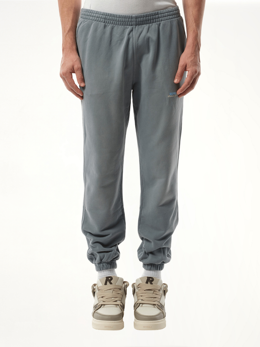 Image of a model wearing Pants. Productname: REPRESENT Patron of The Club Sweatpant in GREY colour by brand - REPRESENT