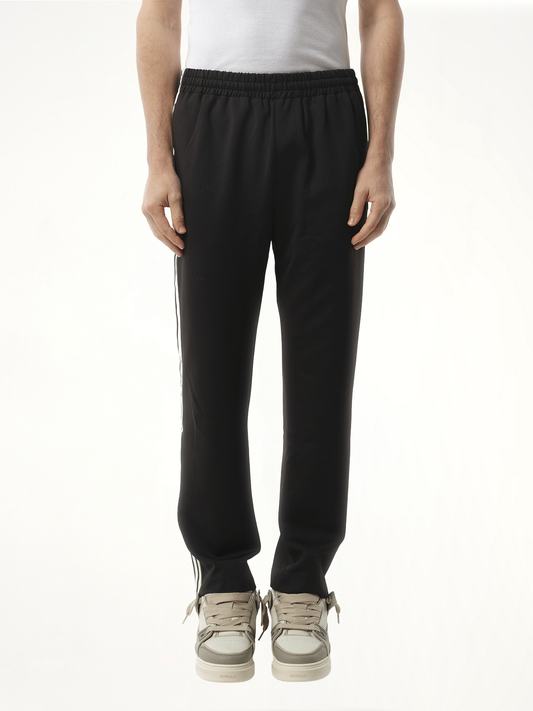 Image of a model wearing Pants. Productname: REPRESENT Tailored Track Pant in BLACK colour by brand - REPRESENT