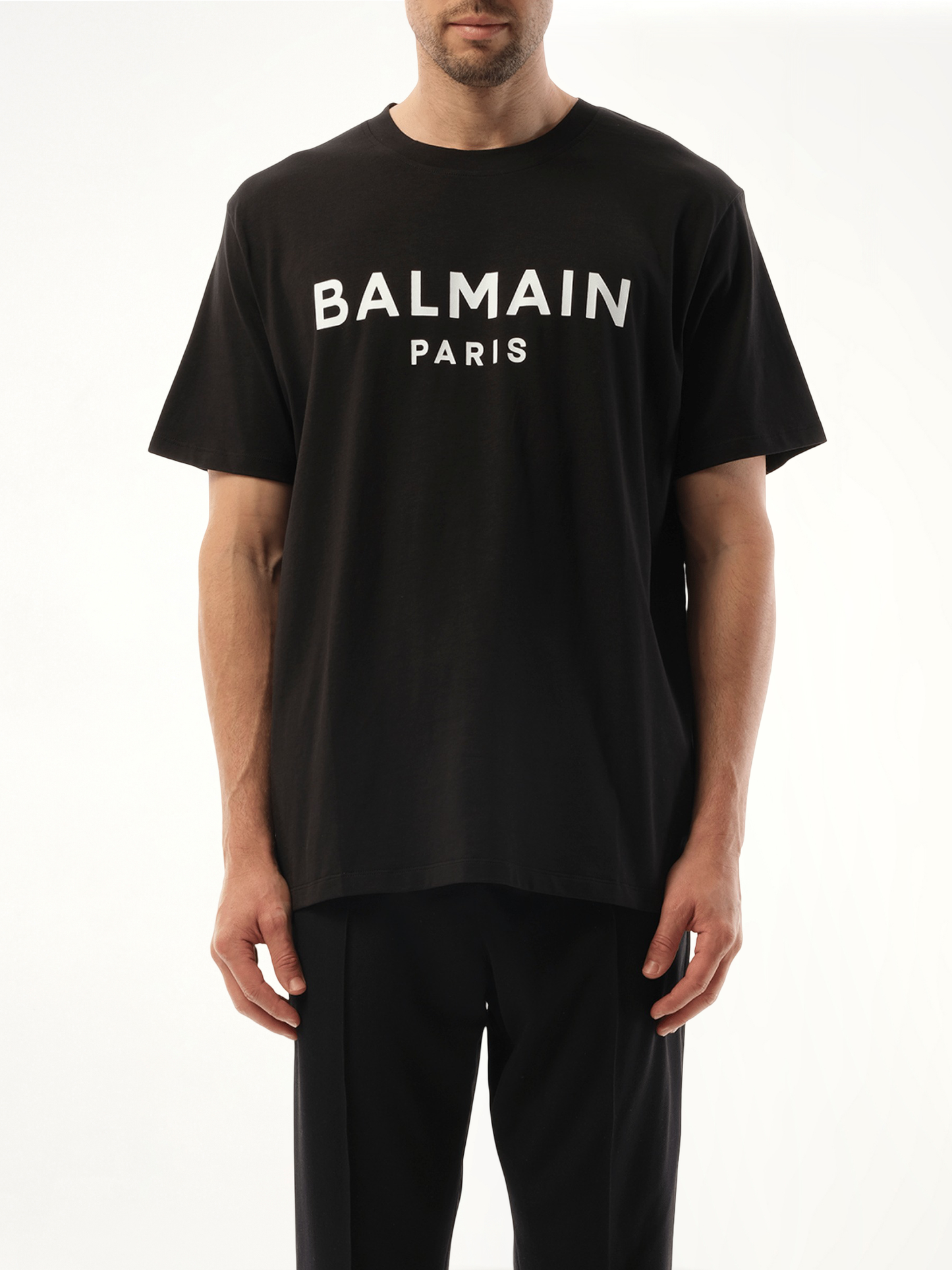 Image of a model wearing Tops. Productname: BALMAIN Balmain Print Reg Fit T-Shirt in Black colour by brand - BALMAIN