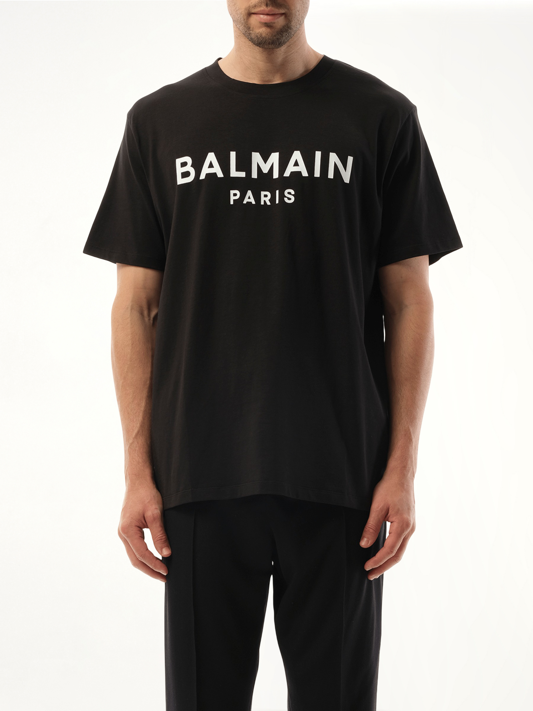 Image of a model wearing Tops. Productname: BALMAIN Balmain Print Reg Fit T-Shirt in Black colour by brand - BALMAIN