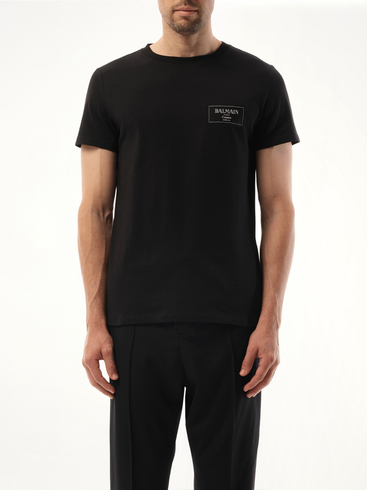 Image of a model wearing Tops. Productname: BALMAIN Couture Label T-Shirt in Black colour by brand - BALMAIN