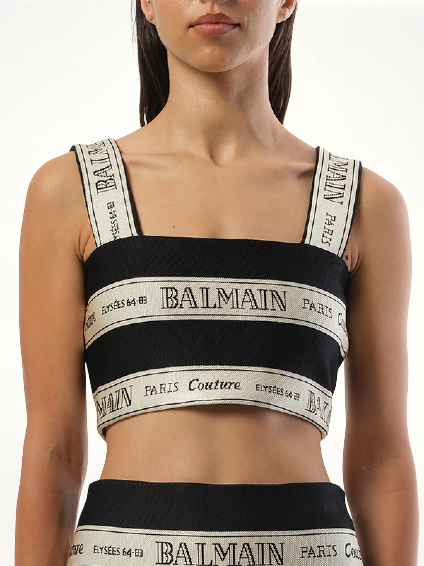 Image of a model wearing Tops. Productname: BALMAIN Striped Balmain Jacquard Crop Top in BLACK colour by brand - BALMAIN