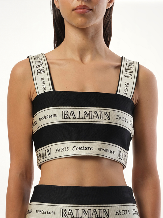 Image of a model wearing Tops. Productname: BALMAIN Striped Balmain Jacquard Crop Top in BLACK colour by brand - BALMAIN