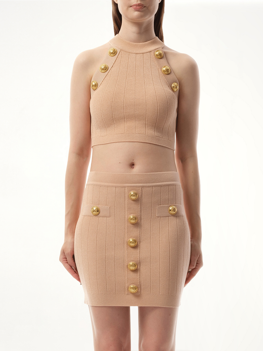 Image of a model wearing Tops. Productname: BALMAIN 6 Button Halterneck Knit Cropped Top in PINK colour by brand - BALMAIN
