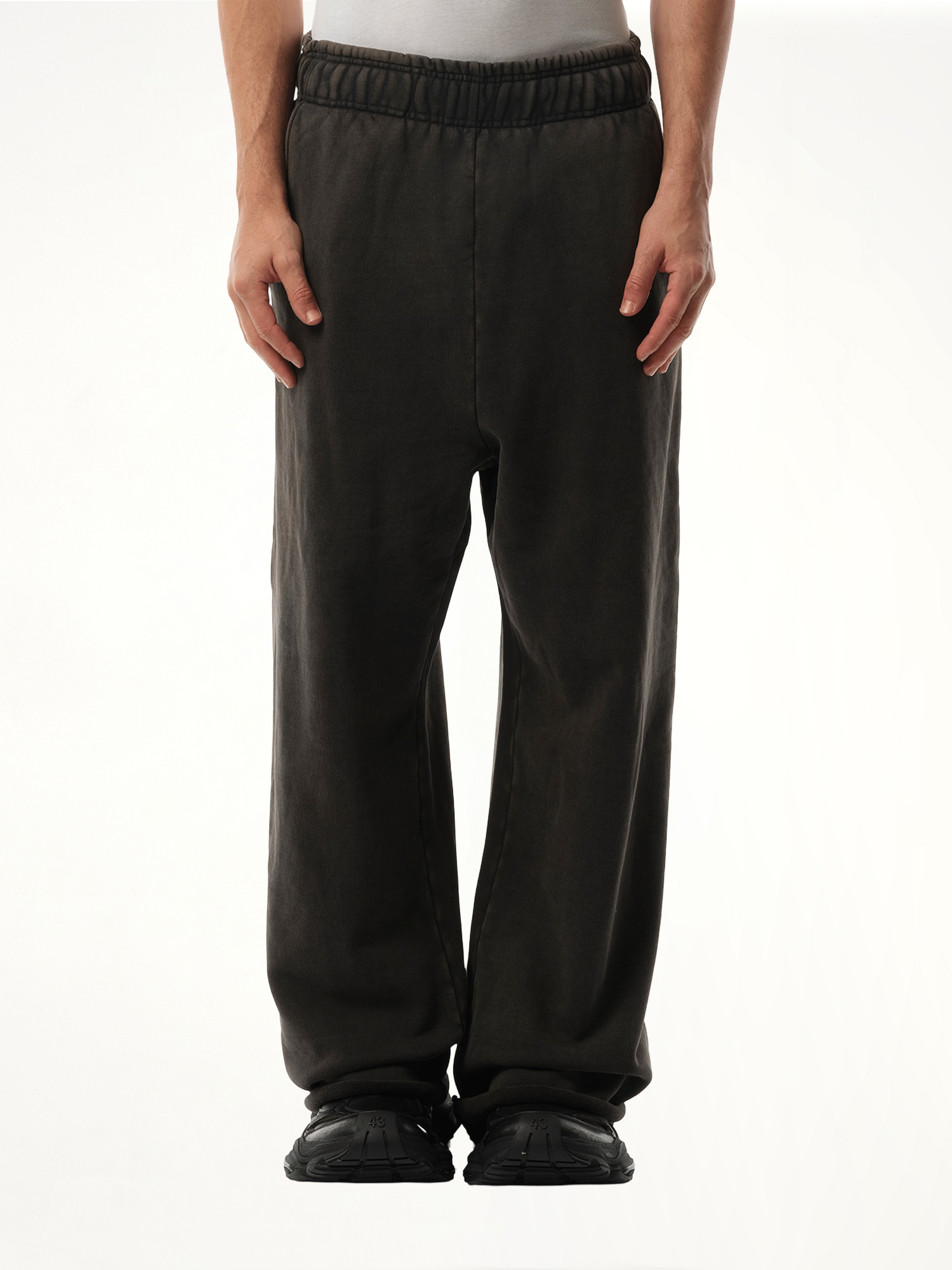 Image of a model wearing Pants. Product name - Full Sweatpants in Black colour by brand - ENTIRE STUDIOS