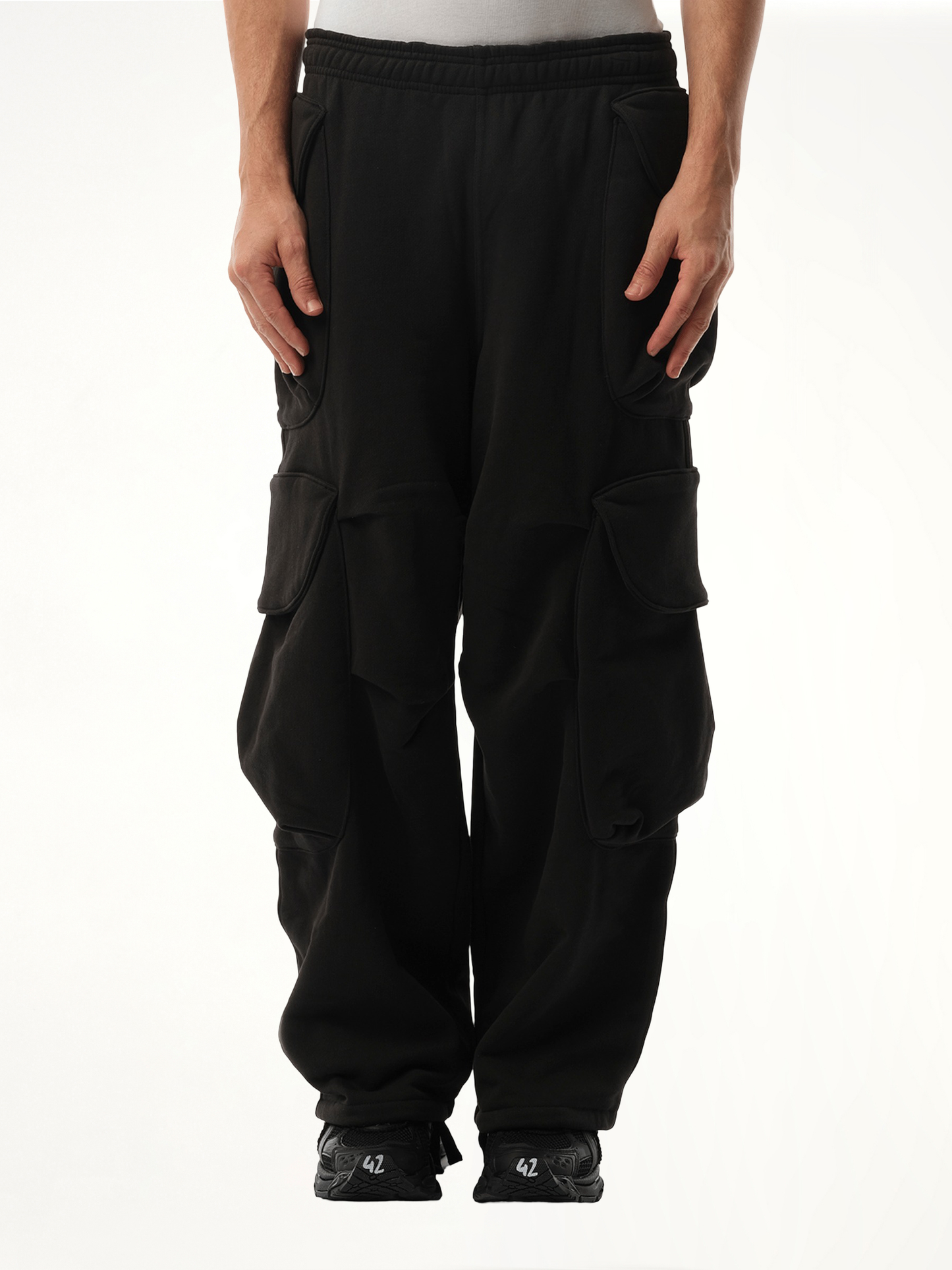 Image of a model wearing Pants. Product name - Heavy Gocar Sweatpants in Black colour by brand - ENTIRE STUDIOS