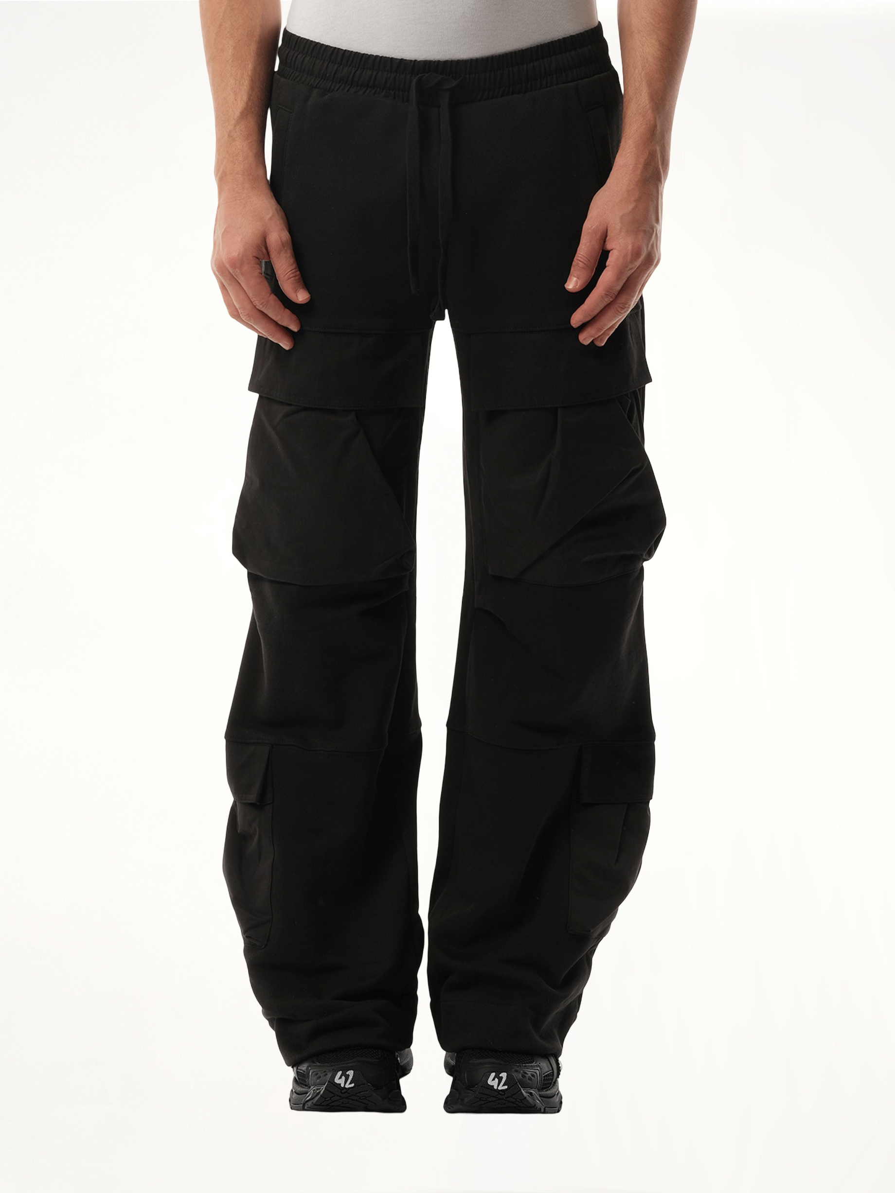 Image of a model wearing Pants. Product name - Utility Sweatpants in Black colour by brand - ENTIRE STUDIOS