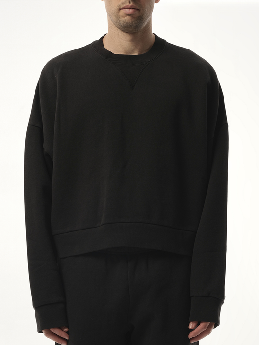 Image of a model wearing Outerwear. Product name - Box Sweatshirt in Black colour by brand - ENTIRE STUDIOS