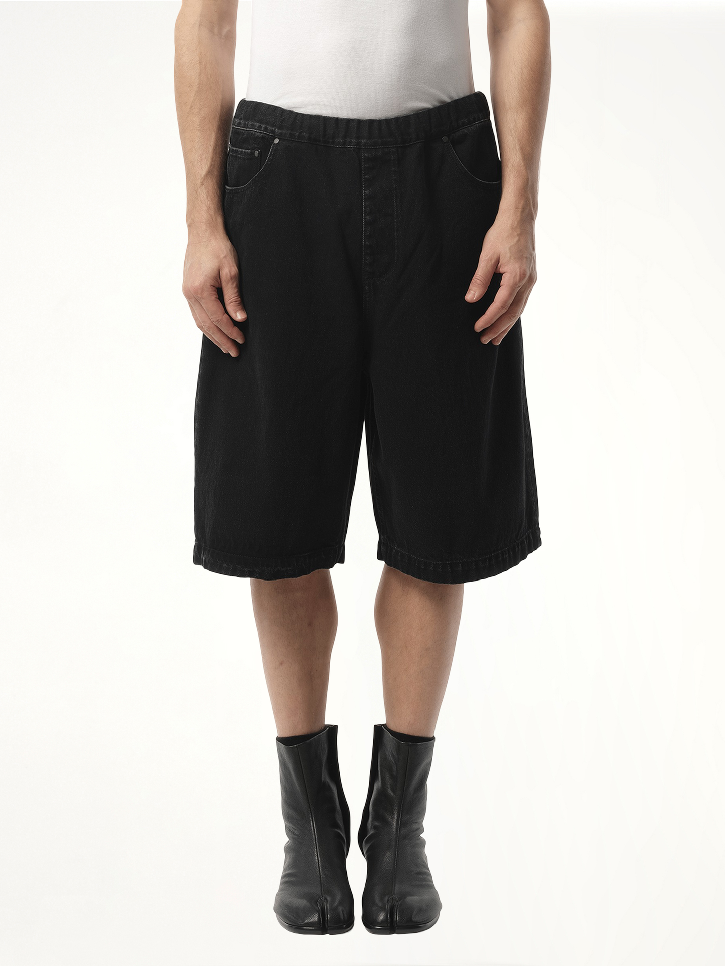 Image of a model wearing Shorts. Product name - Spar Shorts in Black colour by brand - ENTIRE STUDIOS