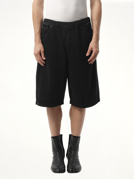 Image of a model wearing Shorts. Product name - Spar Shorts in Black colour by brand - ENTIRE STUDIOS
