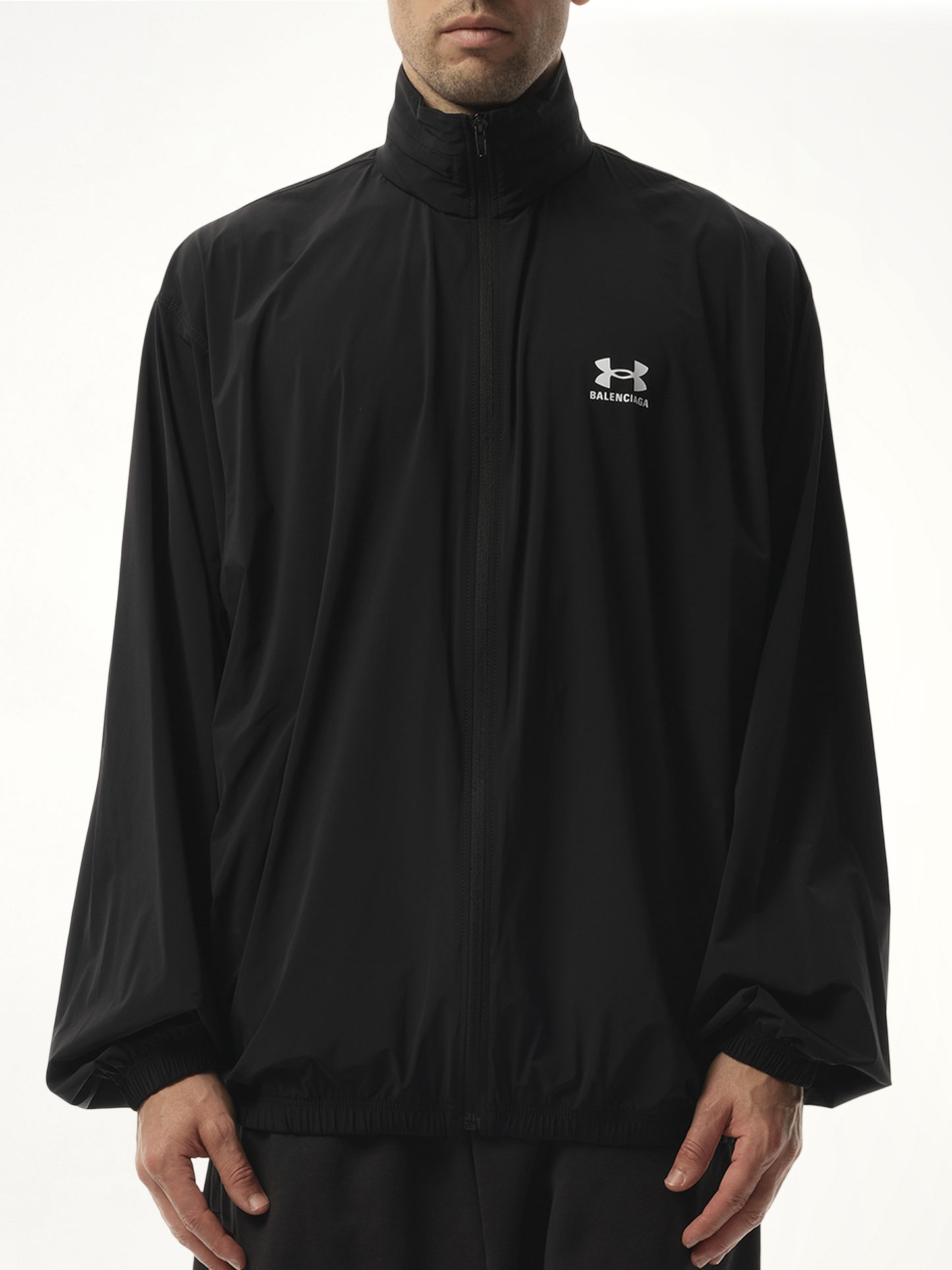 Image of a model wearing Outerwear. Productname: BALENCIAGA Under Armour Windbreaker in Black colour by brand - BALENCIAGA