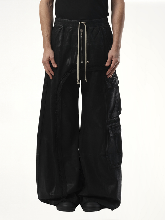 Image of a model wearing Pants. Productname: RICK OWENS DRKSHDW Imbalanced Double Cargo Jumbo Pants in Black colour by brand - RICK OWENS DRKSHDW