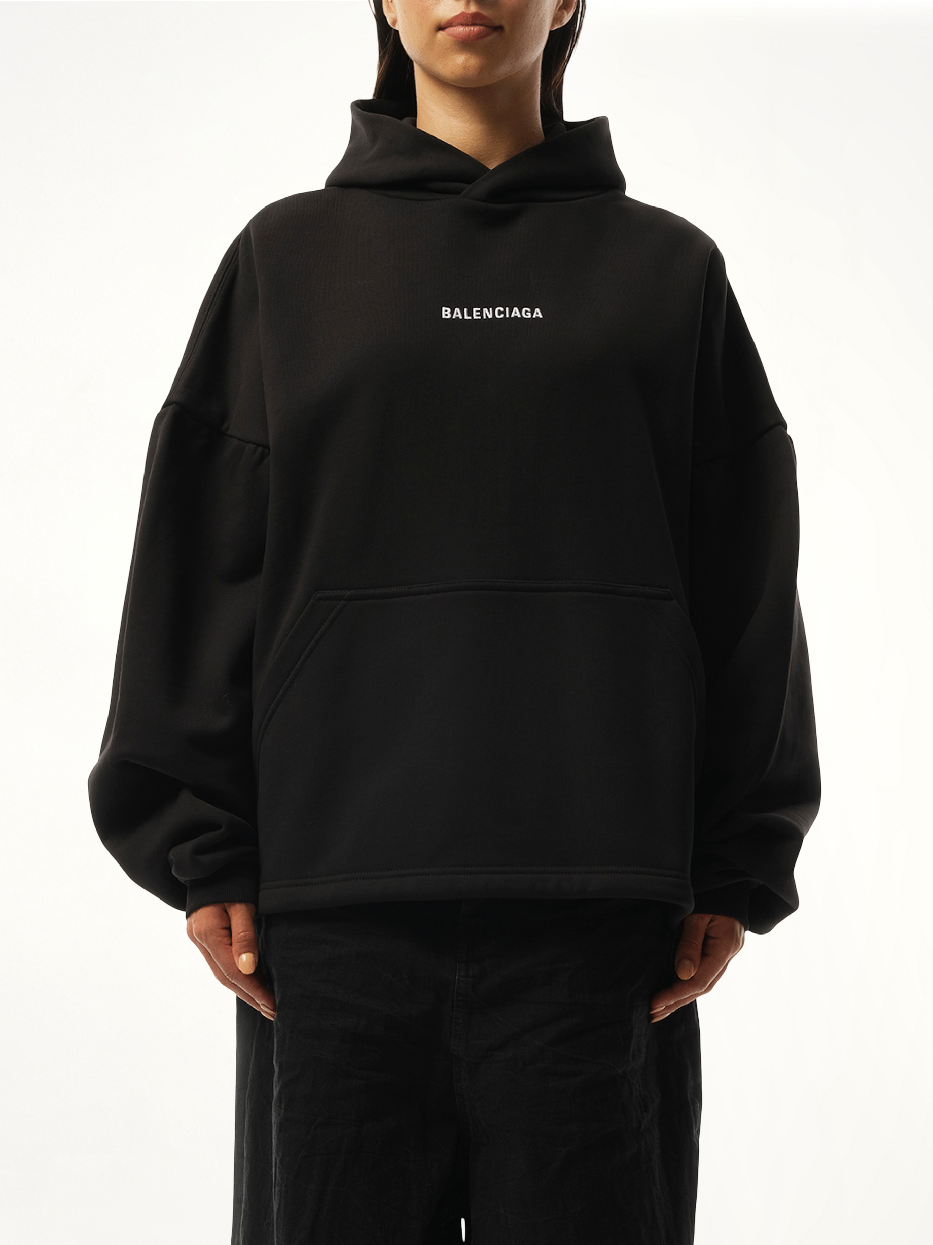 Image of a model wearing Outerwear. Productname: BALENCIAGA Logo Embroidered Hoodie in Black colour by brand - BALENCIAGA