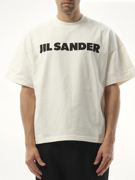 Image of a model wearing Tops. Productname: JIL SANDER Jil Sander Logo T-Shirt in PORCELAIN colour by brand - JIL SANDER